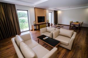 a living room with two couches and a tv at Bang Onsen Spa & Resort in Bang