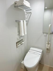 a white bathroom with a toilet and towels at Nplus HOTEL Tokyo Nihonbashi in Tokyo