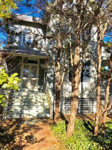a white house with trees in front of it at Beautiful Victorian Home On Ocean Side, in Waretown