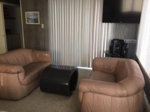 a living room with two couches and a tv at Ocean Views In Loveladies! in Loveladies