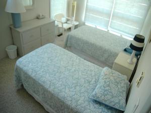 a bedroom with two beds and a desk with a chair at Nice Home In Brant Beach With 4 Bedrooms And Internet in Brant Beach