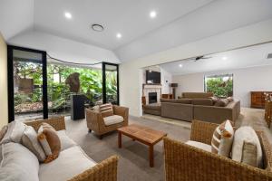 a living room with couches and chairs at 6 Witta Circle, Noosa Heads in Noosa Heads