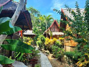 a garden in front of a house at Phi Phi Relax Beach Resort in Phi Phi Islands