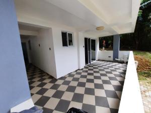 a room with a black and white checkered floor at Olivers Binucot Beach House in Romblon