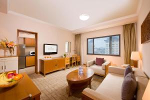 a living room with a couch and a table at Xi'an Dajing Castle Hotel in Xi'an