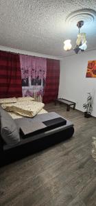 a bedroom with a bed and a ceiling at Casa Suzana 2 camere in Piatra Neamţ