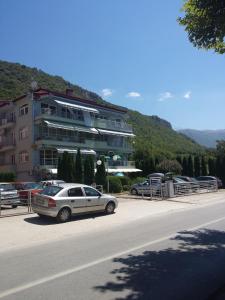 a white car parked in front of a building at Gjole Apartments in Lagadin