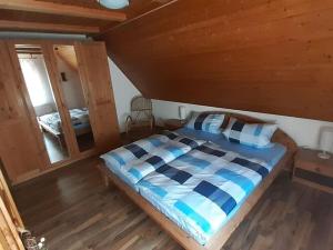 a bedroom with a bed in a wooden cabin at Holiday apartment Renate in Rottenburg