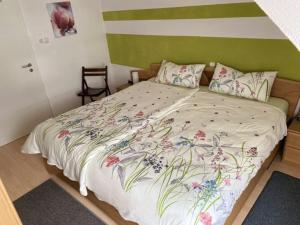 a bedroom with a large bed with a floral bedspread at Apartment Philipps 2 in Graach