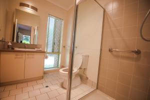 a bathroom with a toilet and a glass shower at Silver Birches Holiday Village - Unit 8 in Bright +12 photos