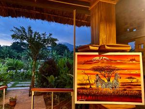 a painting of two zebras in the savanna at Mount Kilimanjaro 360 view Cottage in Uru