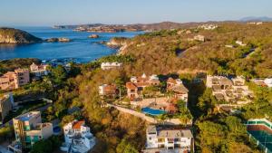 an aerial view of a house on a hill next to the water at Casa Ceiba Huatulco - Adults Only in Santa Cruz Huatulco
