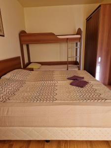 a bed in a room with a bunk bed at Apartment Kalin complex Aurelia-RAVDA in Nesebar