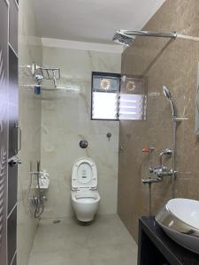 a bathroom with a toilet and a sink at South-East-West Facing 3 BHK Lakeview Flat Howrah West Bengal in Howrah