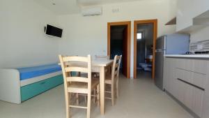 - une cuisine avec une table et des chaises dans la chambre dans l'établissement appartamenti baia di peschici, à Peschici