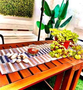 a wooden table with food on top of it at Violeta loft A with chill out terrace Sevilla in Seville