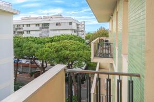 an apartment balcony with a view of a city at Casa Vacanza Rimini in Rimini