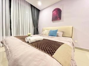 a bedroom with a large bed with towels on it at D'Chill Suite【Austin Regency】Netflix in Johor Bahru +44 photos