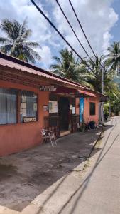 a building with a bench in front of a street at SPC South Pacific Chalet SP Barakah at ABC Air Batang Village in Tioman Island