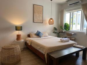 a bedroom with a bed and a table and a window at Notre Maison 5 Saigon close Walking street in Thao Dien D2 in Ho Chi Minh City +207 photos