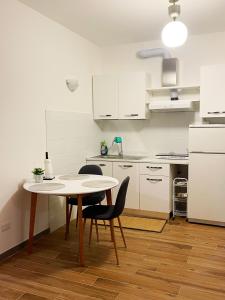 a kitchen with a table and chairs in a room at Brand New Panoramic Apartment in Vitinia