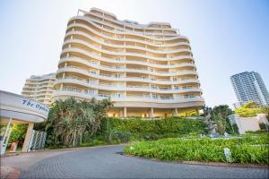 a large building with a road in front of it at 603 Oyster Rock Umhlanga Rocks in Durban