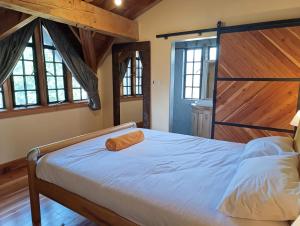 a bed in a room with wooden floors and windows at Amani House in Nairobi