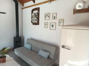 a living room with a couch and a stove at La Barraca de Ro-Casa en el campo con piscina-50 kilimetros de la playa in La Ñora