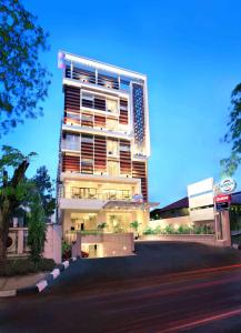 a tall building with lights on the side of it at Cordela Hotel Cirebon in Cirebon