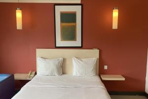 a bedroom with a bed with two white pillows at Hotel Glodok Plaza in Jakarta