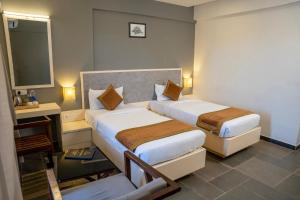 Hotel Dwarawata客房内的一张或多张床位