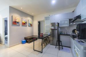 a kitchen with a table and a refrigerator at Sky Suites in George Town