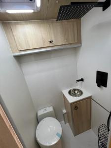 a small bathroom with a toilet and a sink at Renka Holidays Houses and Caravans in Alanya