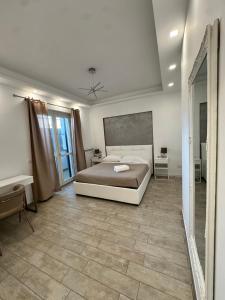 a large bedroom with a bed and a mirror at Coho House Fiumicino in Fiumicino