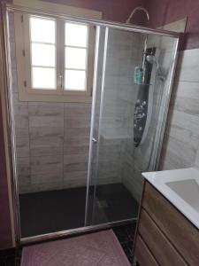 a shower with a glass door in a bathroom at Maison à la campagne in Saint-Pierre-les-Étieux