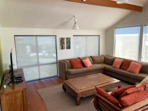 a living room with a couch and a coffee table at Blue Ocean Haven - Expansive Ocean Views in this Classic Family Beach House in Peppermint Grove Beach in Capel