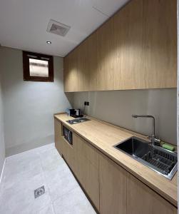 a kitchen with a sink and a counter top at Maz Apartments in Al Madinah