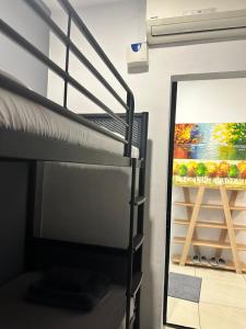 a bunk bed in a room with a painting on the wall at ITCC Manhattan Suites by LAVISH in Kota Kinabalu