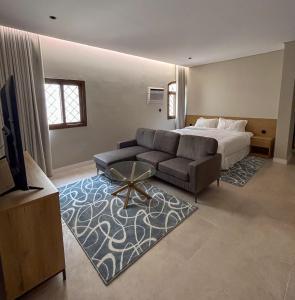 a hotel room with a bed and a couch at Maz Apartments in Medina +14 photos