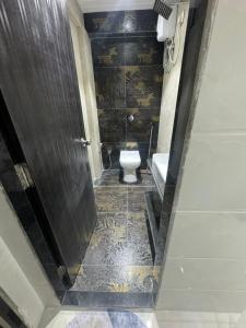 a bathroom with a toilet and a sink at Backpackers Villa Mumbai in Mumbai