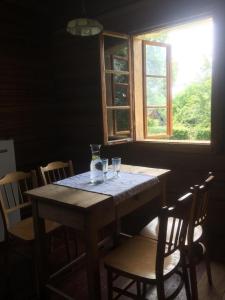 a wooden table in a room with a window at Ferienhaus in Zawada mit Grill und Terrasse 