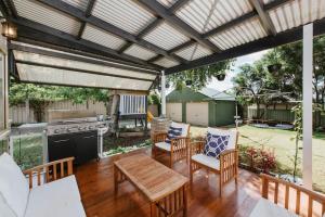 a patio with a table and chairs and a grill at 'The Nicholson' A Central and Charming Cottage in Mudgee in Mudgee