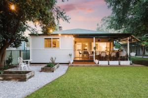 a small white house with a patio at 'The Nicholson' A Central and Charming Cottage in Mudgee in Mudgee