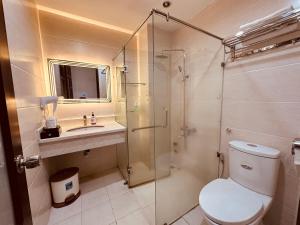 a bathroom with a toilet and a sink and a shower at REDFLOWER HOTEL in Ho Chi Minh City