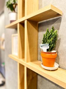 a potted plant sitting on a wooden shelf at Osaka Ebisu Hotel in Osaka