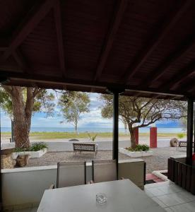 a table and chairs with a view of a park at Studios Resbithas in Gythio