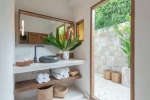 a bathroom with a mirror and a sink at Tropical Villa Canggu Beach in Dalung +28 photos