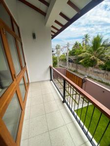 a balcony with a view of the ocean at THE DOCTORS VILLA in Ragama