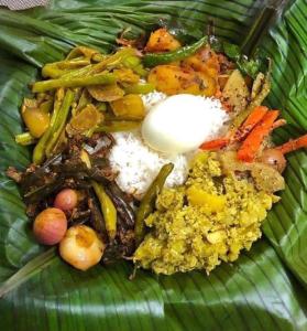un plato de comida encima de una hoja verde en Sigiri Panaromic Tree House, en Sigiriya