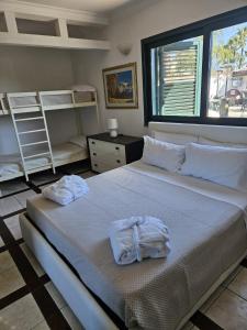 a bedroom with a bed with towels on it at Villa Courrier in Tremestieri Etneo